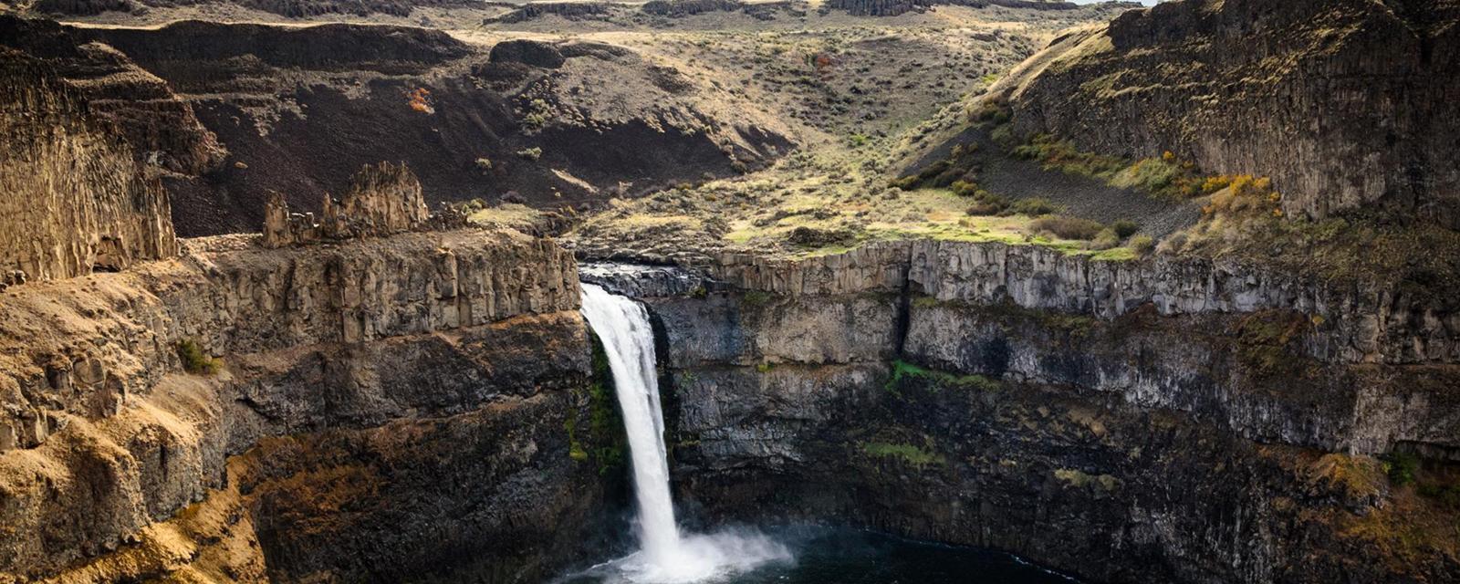 Breaking records

Dry Falls (pictured), the site of a former waterfall, is a horseshoe-shaped cliff that’s twice as high and three times as wide as Niagara Falls, making it the largest confirmed waterfall in the planet’s history. Today, the site is preserved as Sun Lakes-Dry Falls State Park, where visitors can see the impact of these relatively recent geologic events through overlooks, canyon trails and interpretative displays. (Credit: Zack Frank)