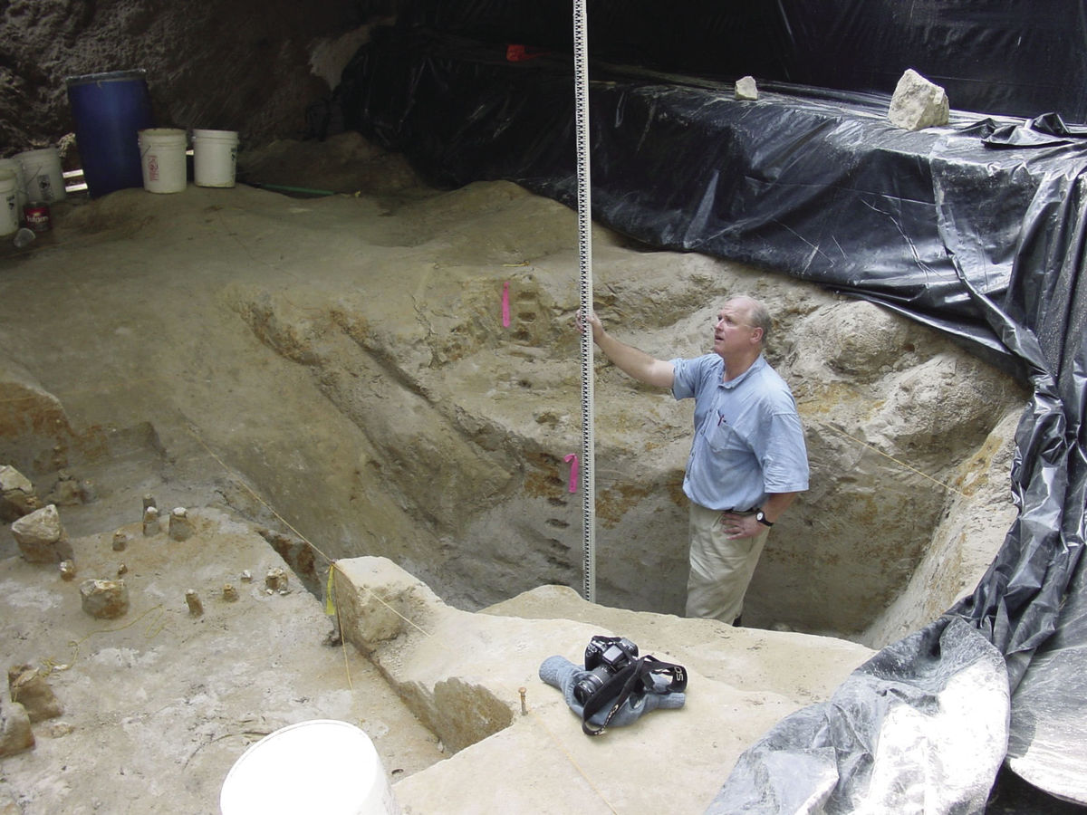 Archaeologist Al Goodyear measures the depth of a dig at the Topper site near Allendale where evidence of human occupation has been found that Goodyear said dates back 50,000 years.